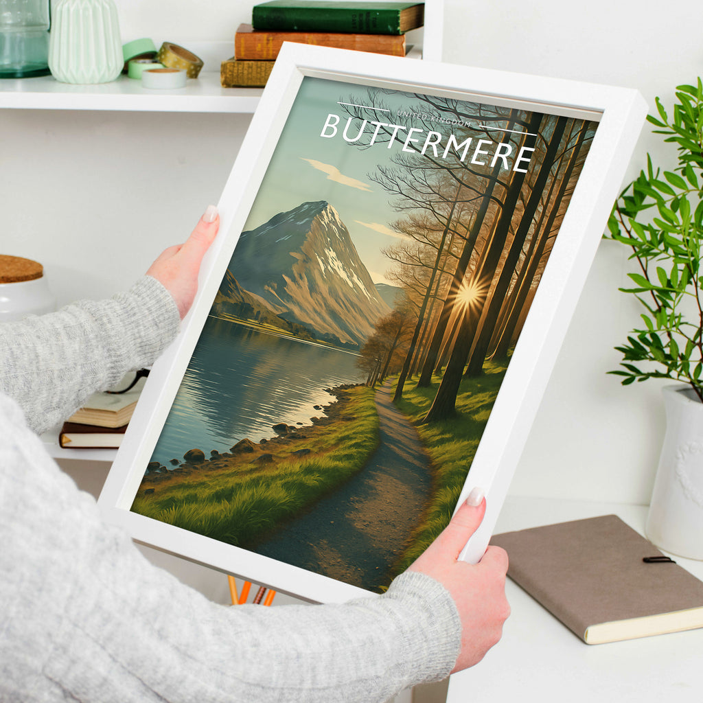 Buttermere #2 Travel Poster in a white frame, held to show scale