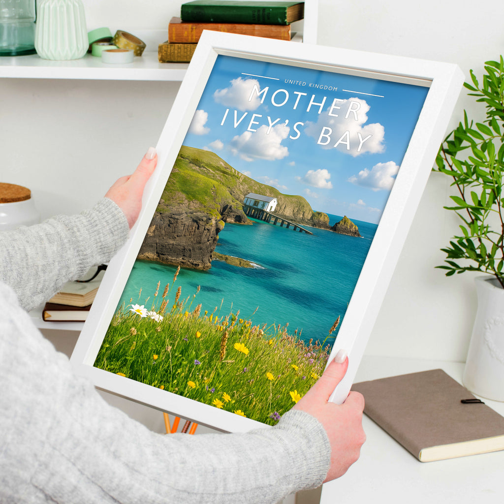 Mother Ivey’s Bay Travel Poster in a white frame, held to show scale