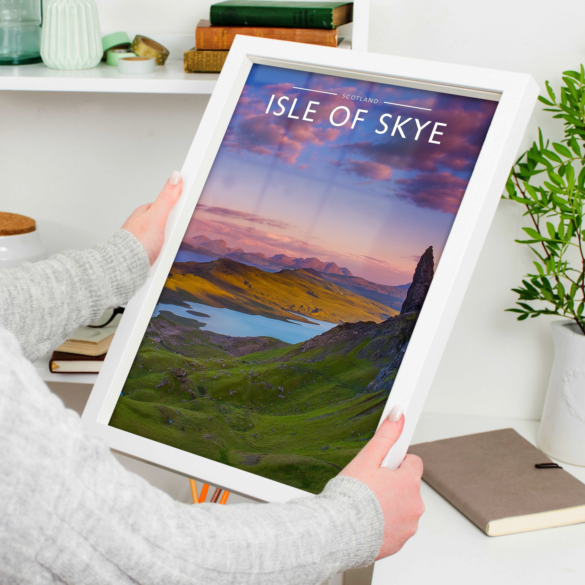 Isle of Skye Travel Poster in a white frame, held to show scale