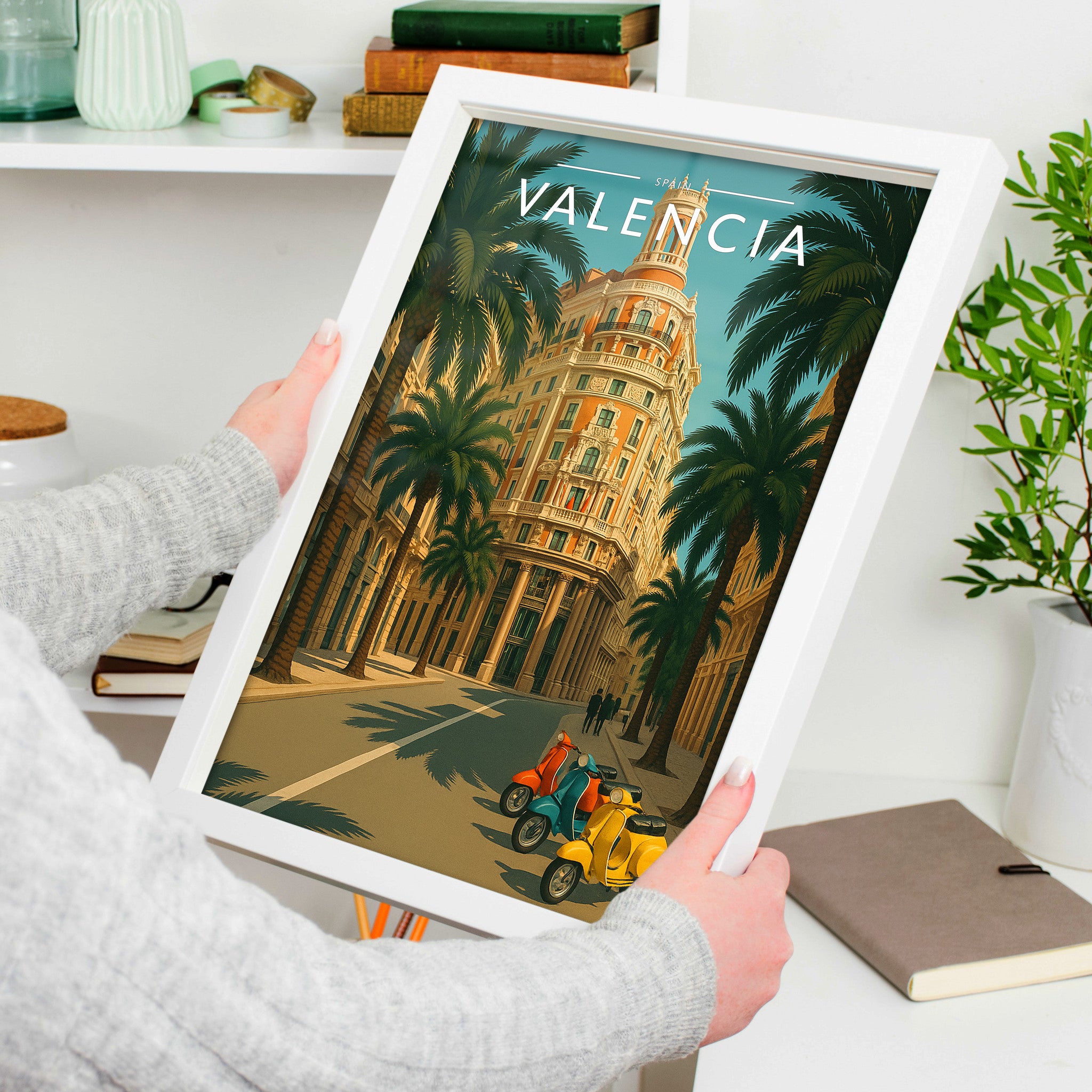 Valencia Travel Poster in a white frame, held to show scale