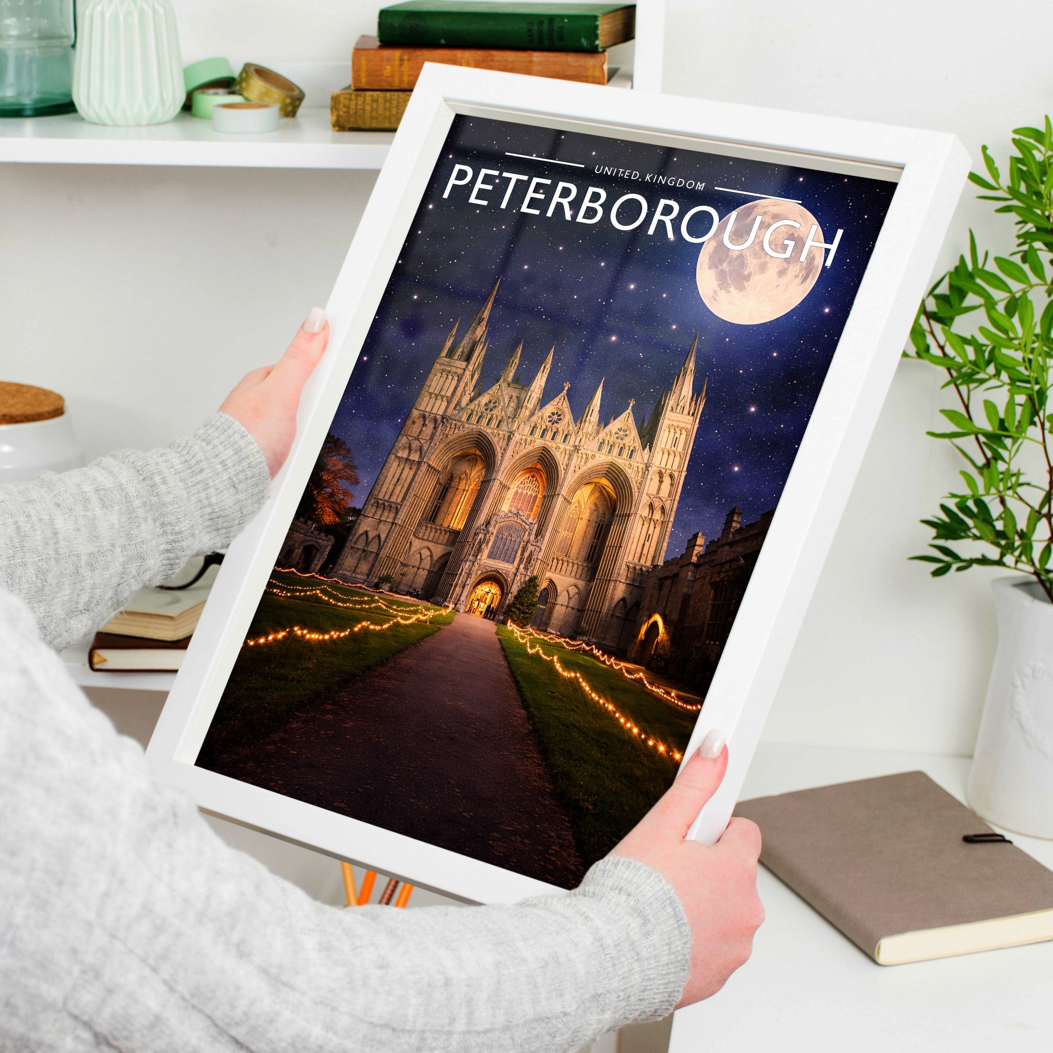 Peterborough #4 Travel Poster in a white frame, held to show scale