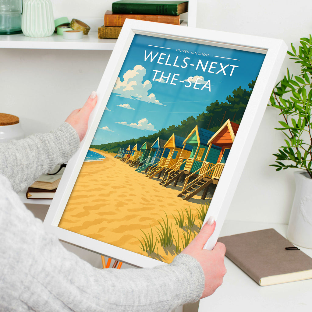 Wells-next-the-Sea Travel Poster in a white frame, held to show scale