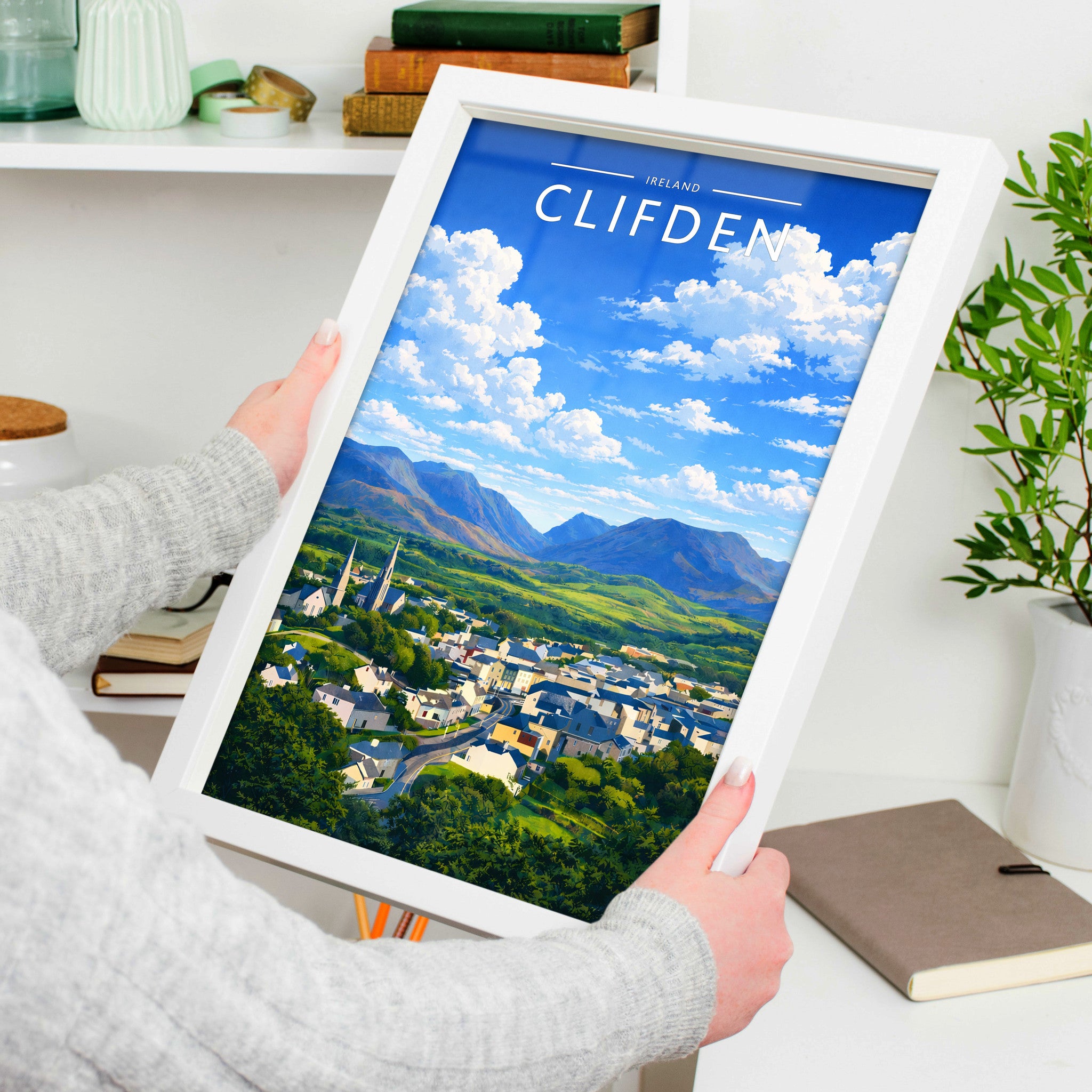 Clifden Travel Poster in a white frame, held to show scale