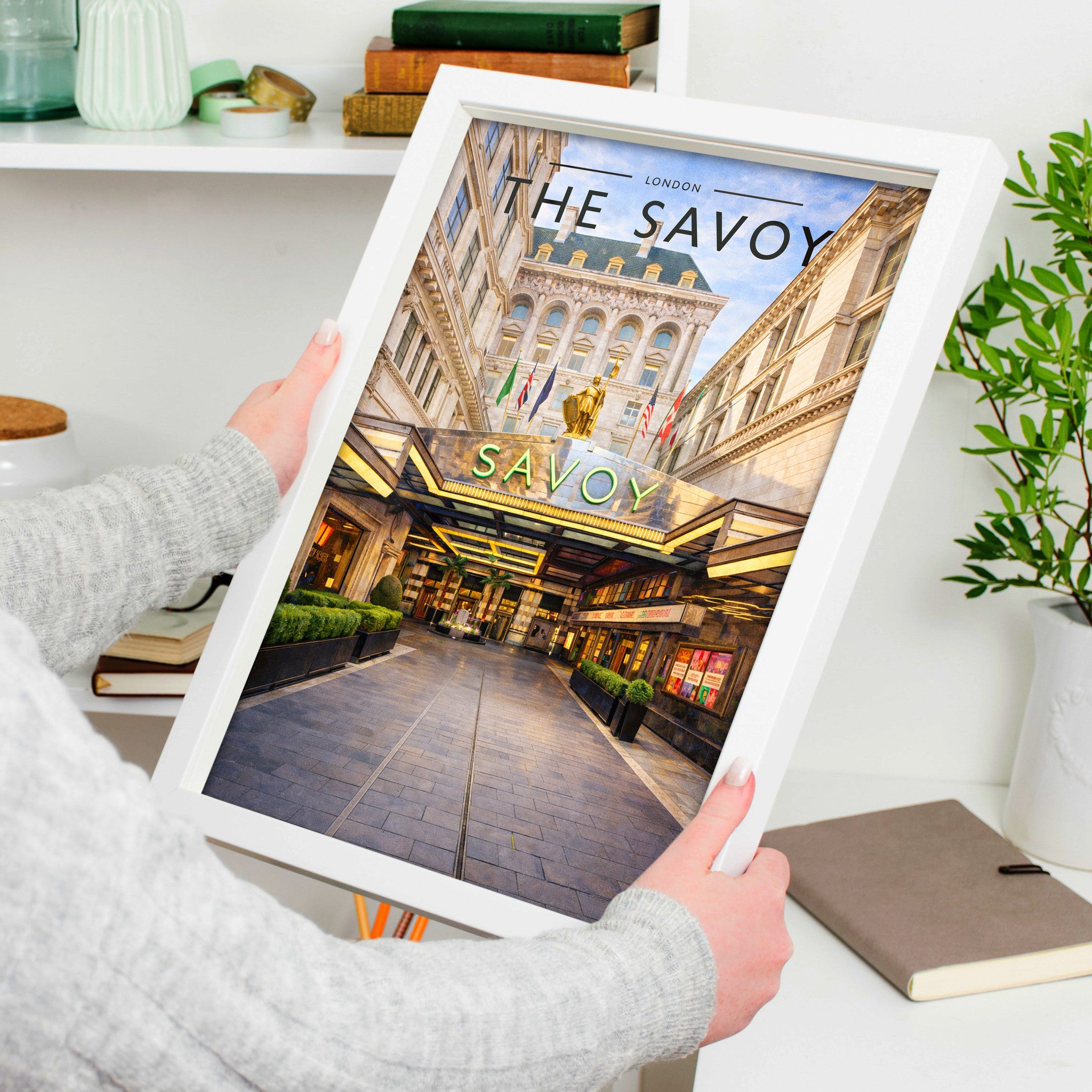 London #4 Travel Poster in a white frame, held to show scale