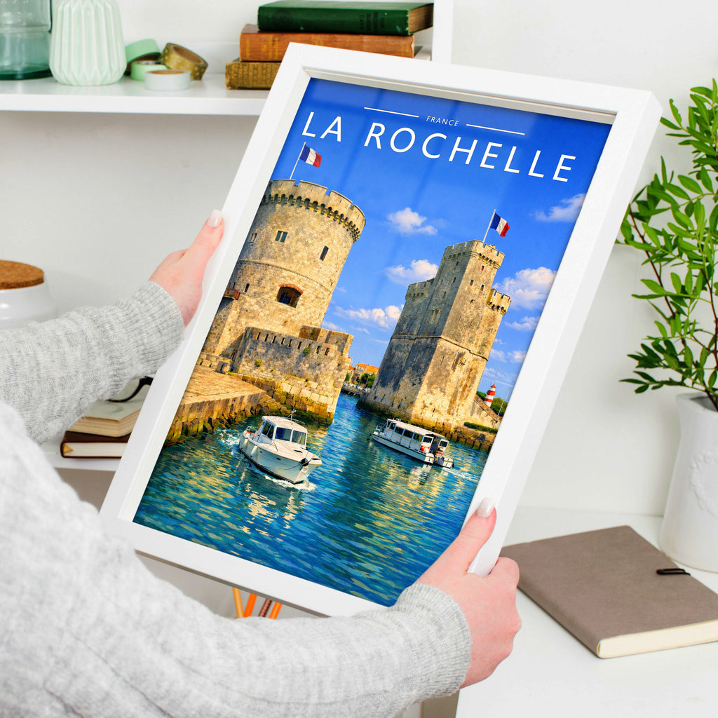La Rochelle Travel Poster in a white frame, held to show scale