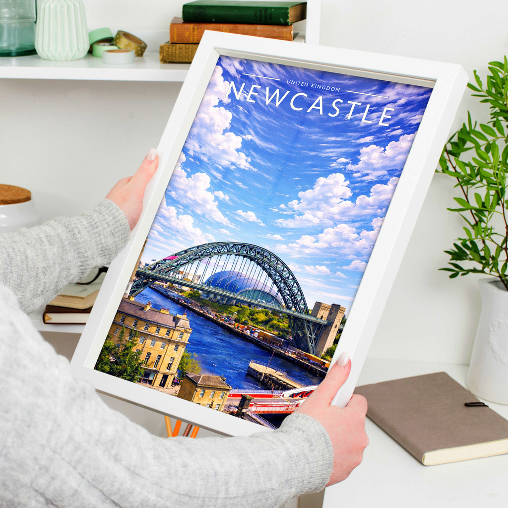 Newcastle Travel Poster in a white frame, held to show scale