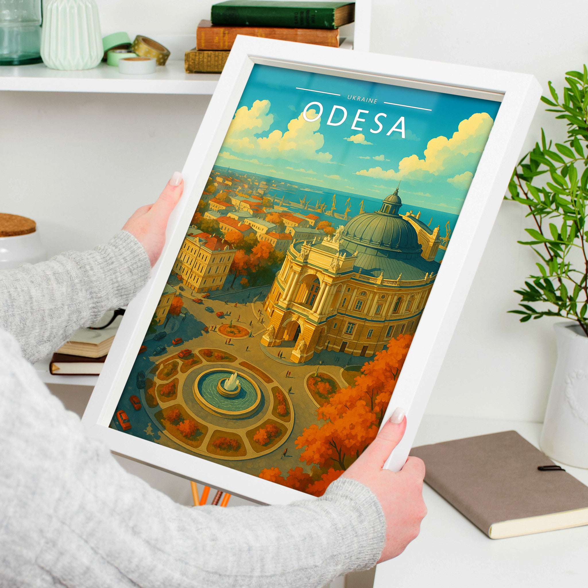 Odesa Travel Poster in a white frame, held to show scale