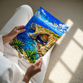 Blue Grotto Travel Poster - A4 print held in hand