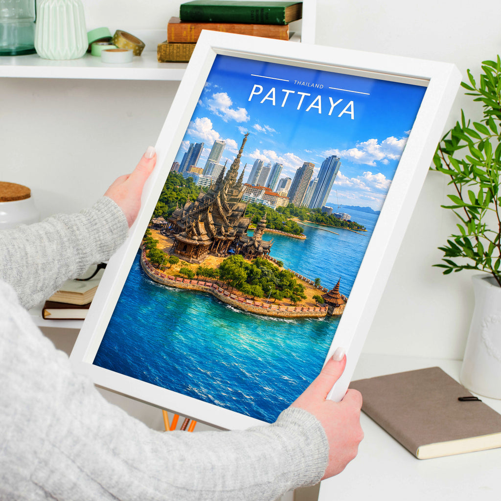 Pattaya Travel Poster in a white frame, held to show scale
