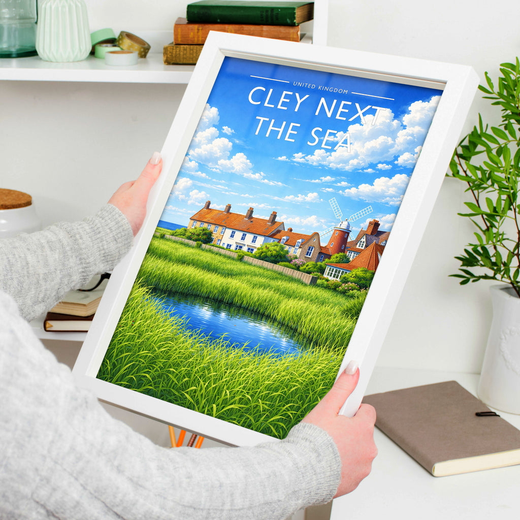 Cley next the Sea Travel Poster in a white frame, held to show scale