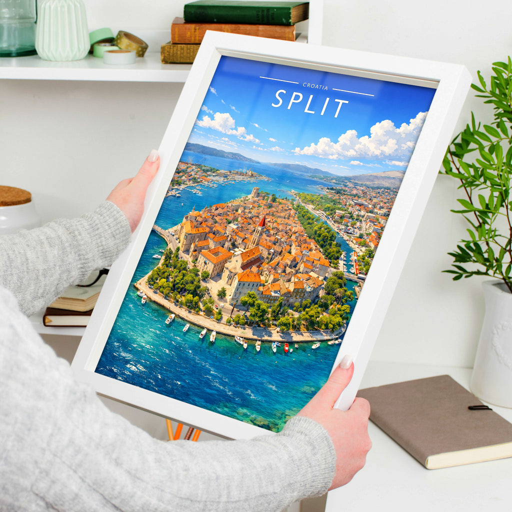 Split Travel Poster in a white frame, held to show scale