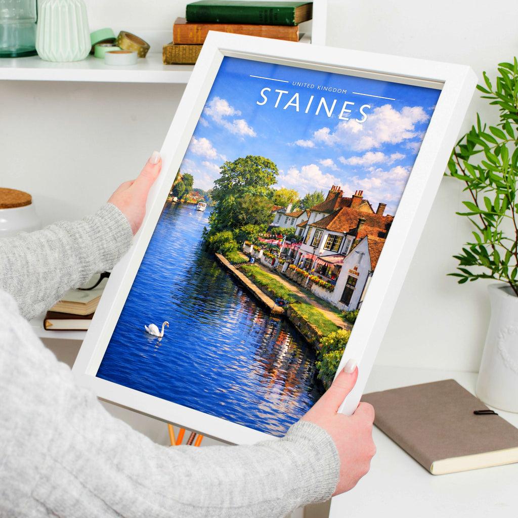 Staines Travel Poster in a white frame, held to show scale