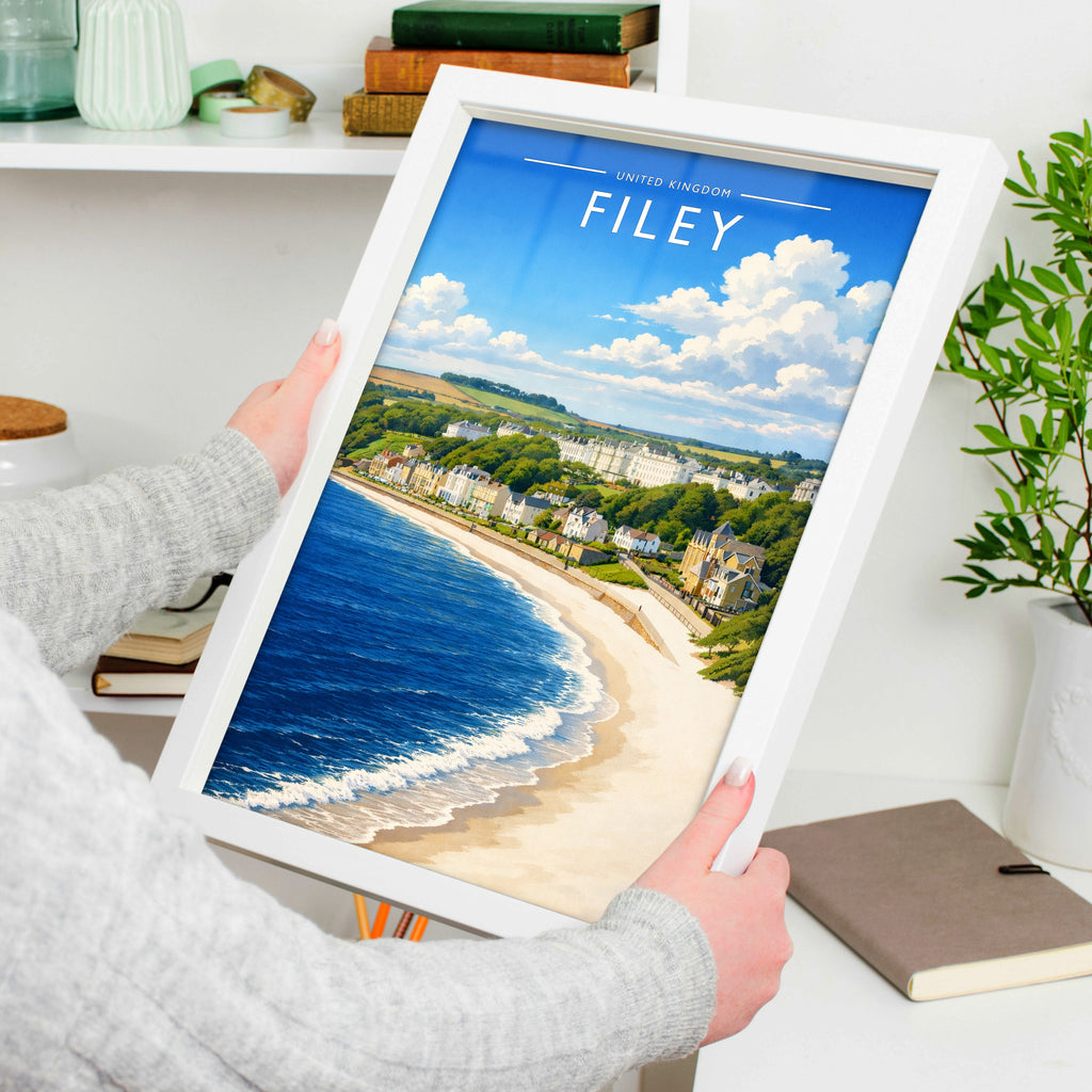 Filey Travel Poster in a white frame, held to show scale