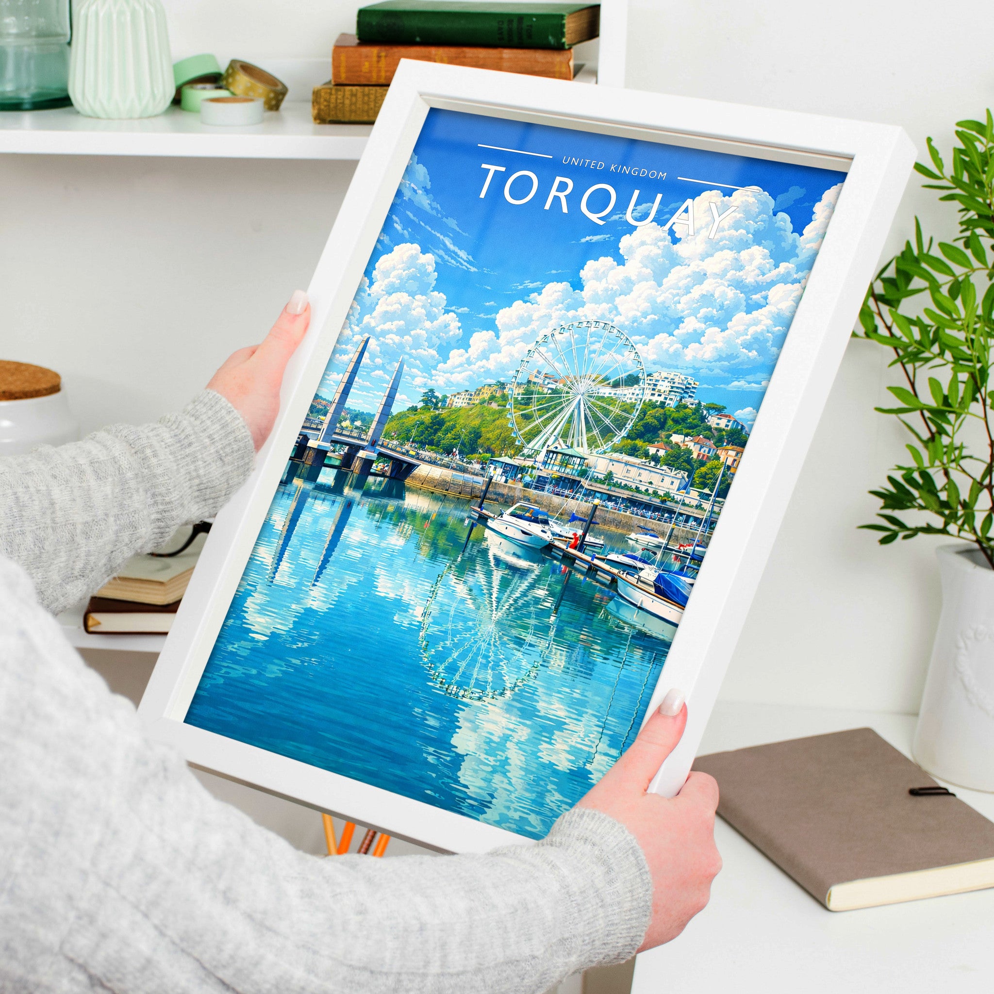 Torquay Travel Poster in a white frame, held to show scale