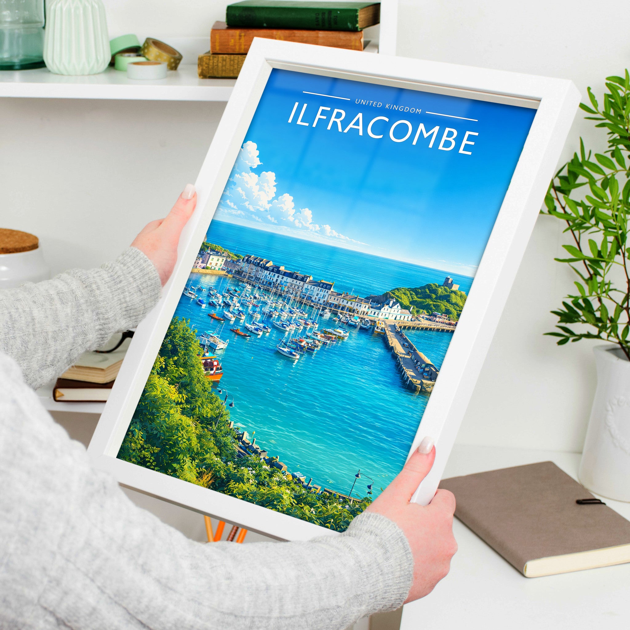 Ilfracombe Travel Poster in a white frame, held to show scale