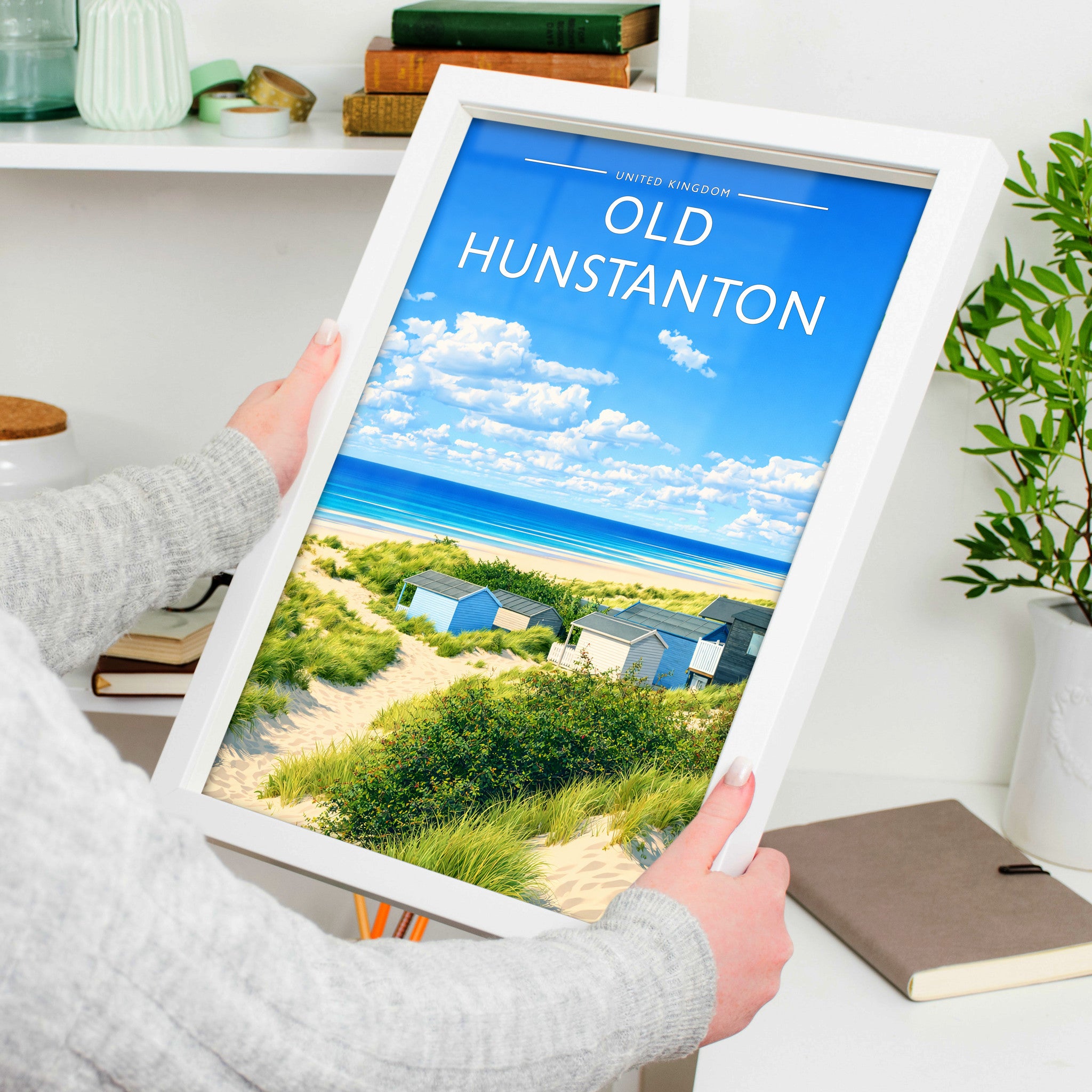 Old Hunstanton Travel Poster in a white frame, held to show scale