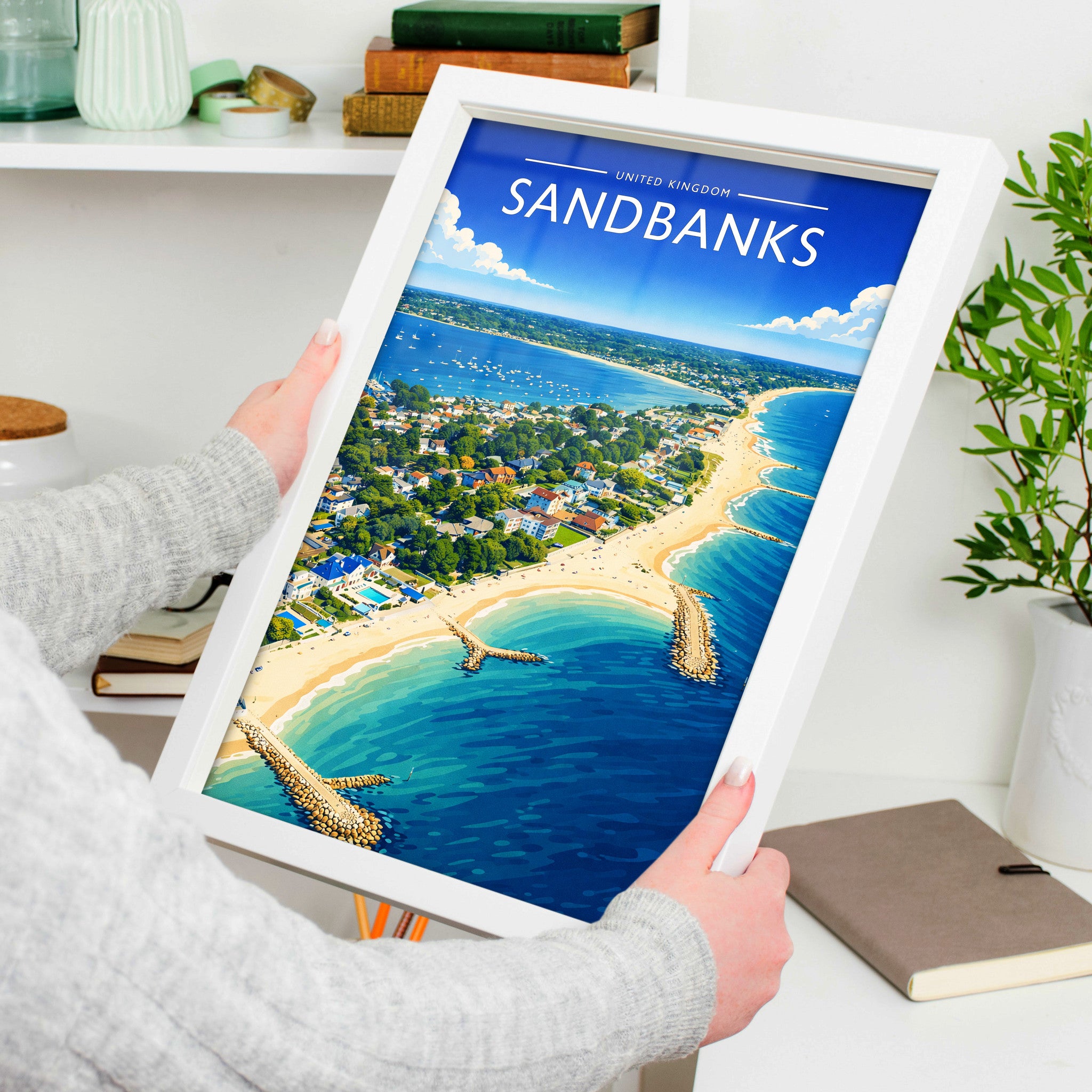 Sandbanks Travel Poster in a white frame, held to show scale