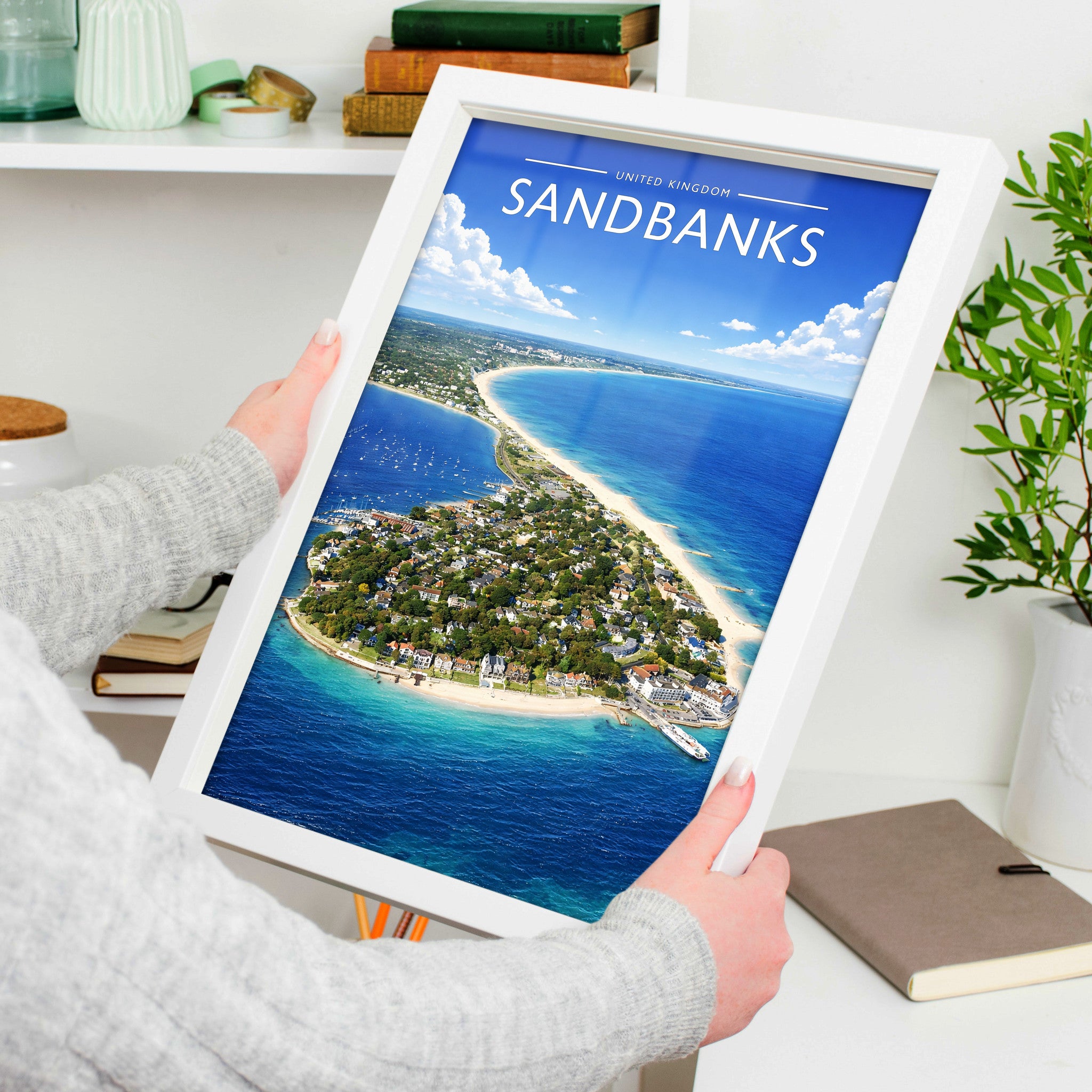 Sandbanks #2 Travel Poster in a white frame, held to show scale