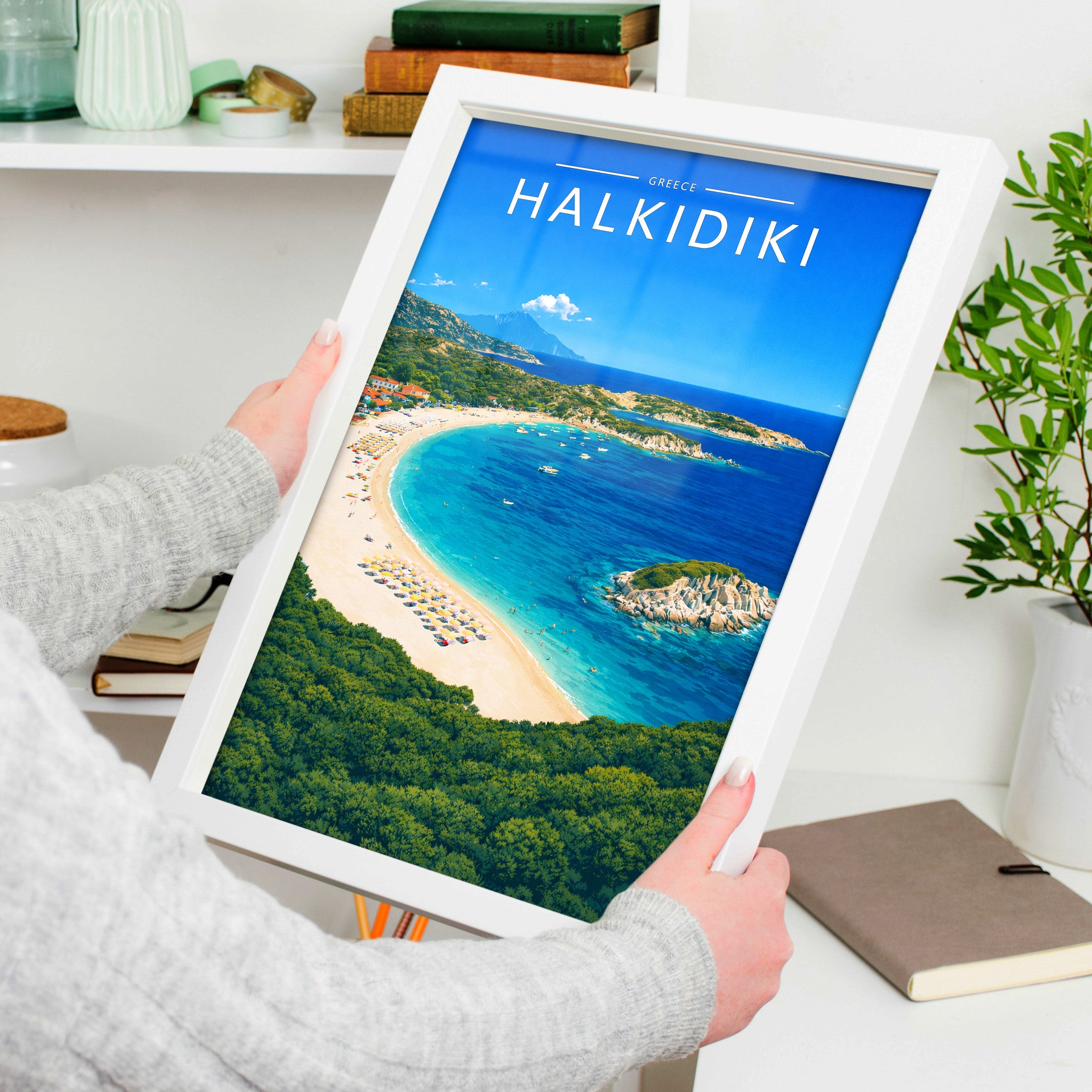 Halkidiki Travel Poster in a white frame, held to show scale
