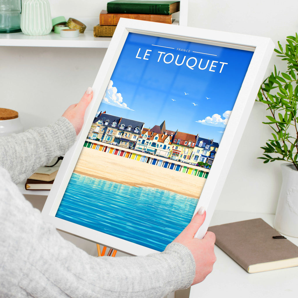Le Touquet Travel Poster in a white frame, held to show scale