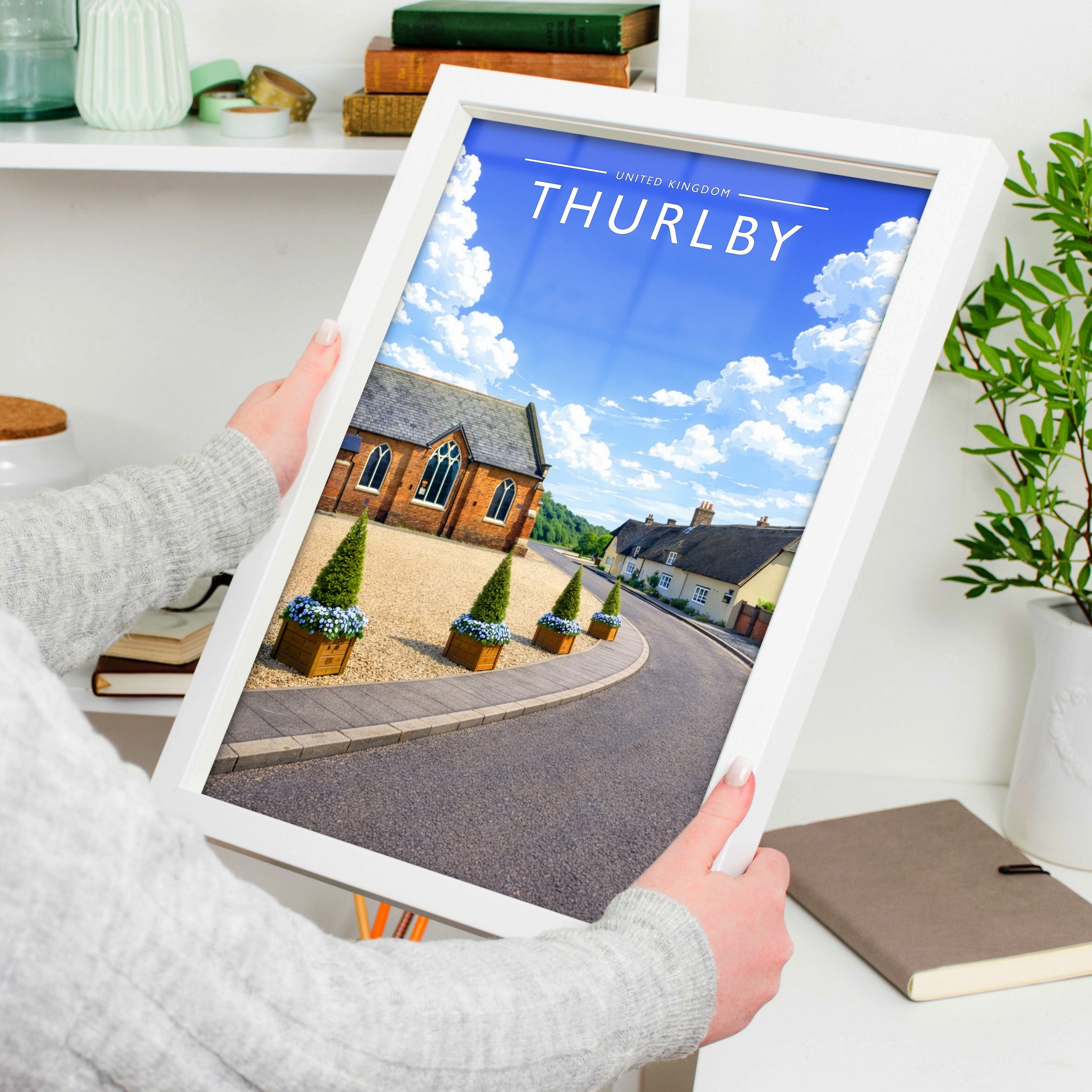 Thurlby Travel Poster in a white frame, held to show scale
