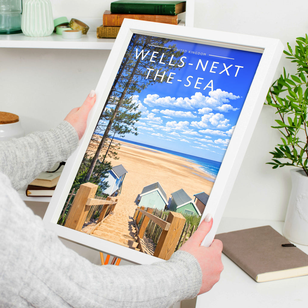 Wells-next-the-Sea #2 Travel Poster in a white frame, held to show scale