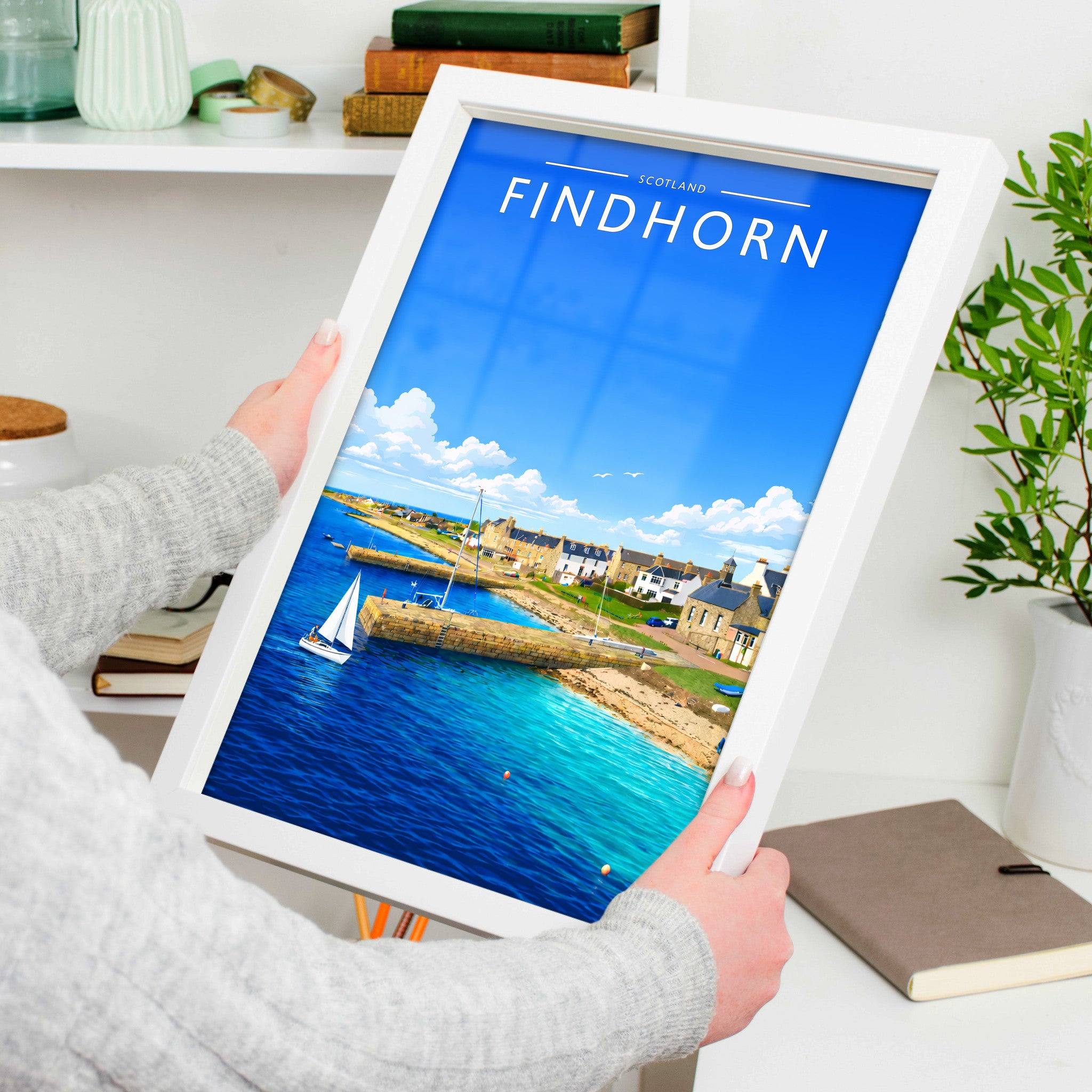 Findhorn Travel Poster in a white frame, held to show scale