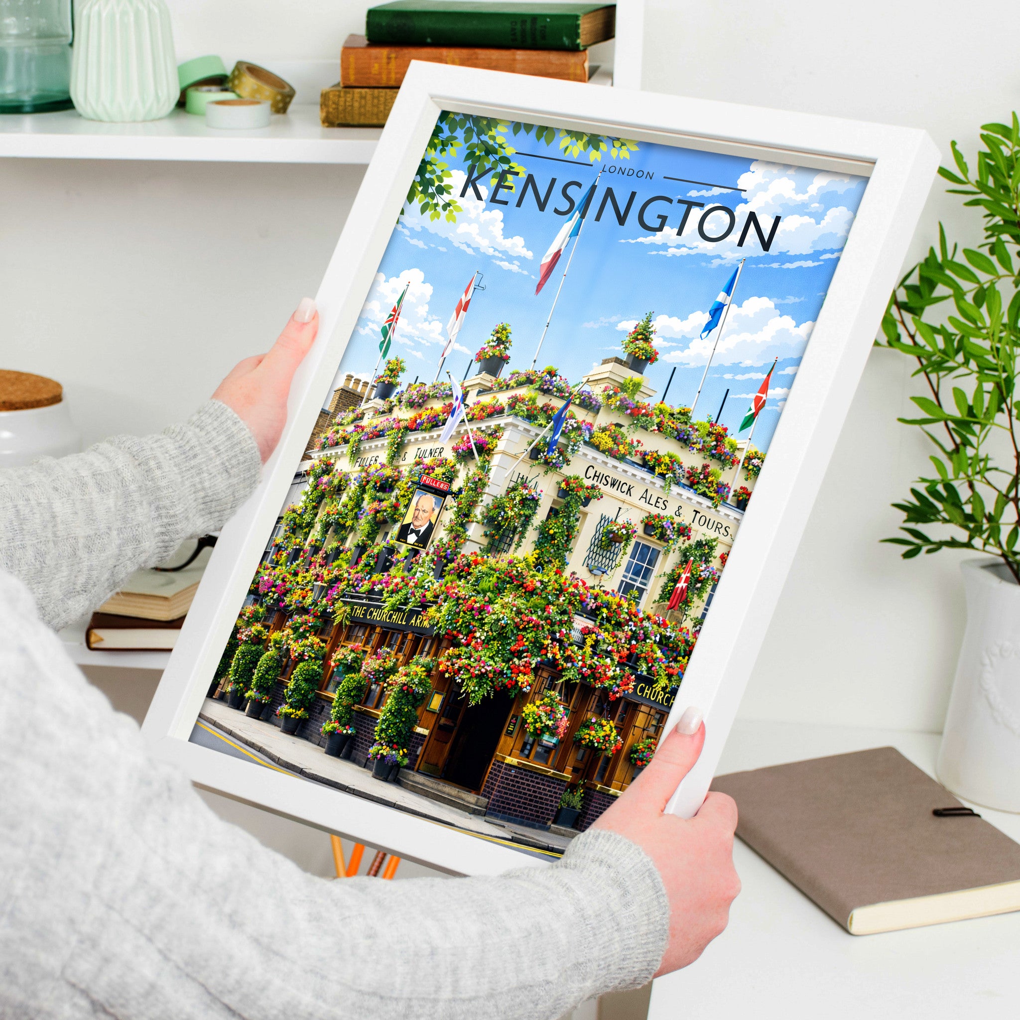 Kensington #2 Travel Poster in a white frame, held to show scale