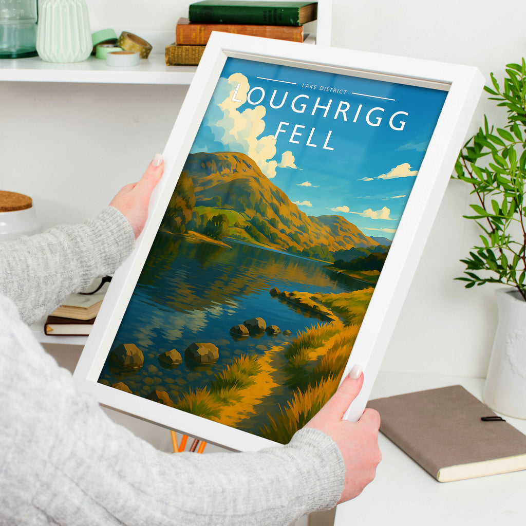 Loughrigg Fell Travel Poster in a white frame, held to show scale