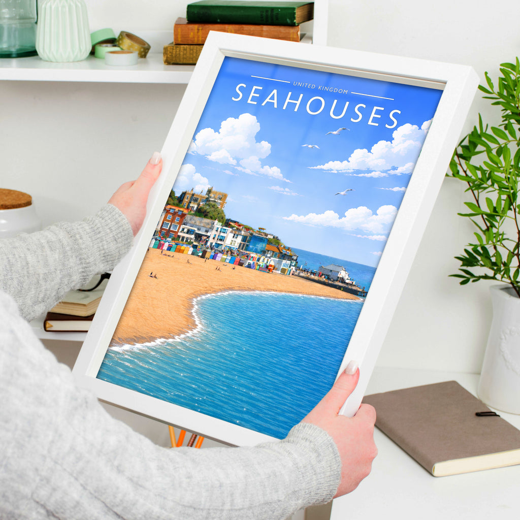 Seahouses #2 Travel Poster in a white frame, held to show scale