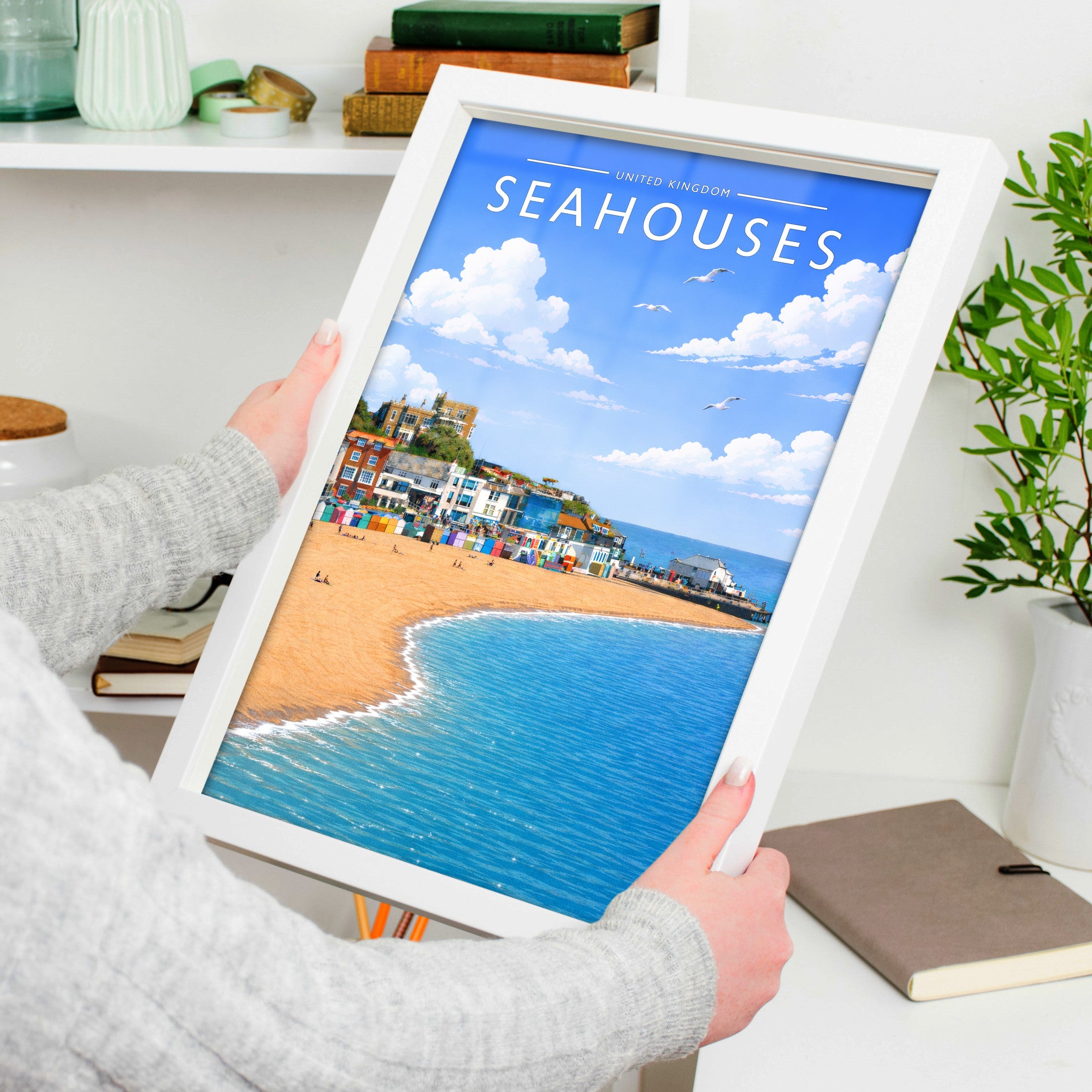 Seahouses #2 Travel Poster in a white frame, held to show scale