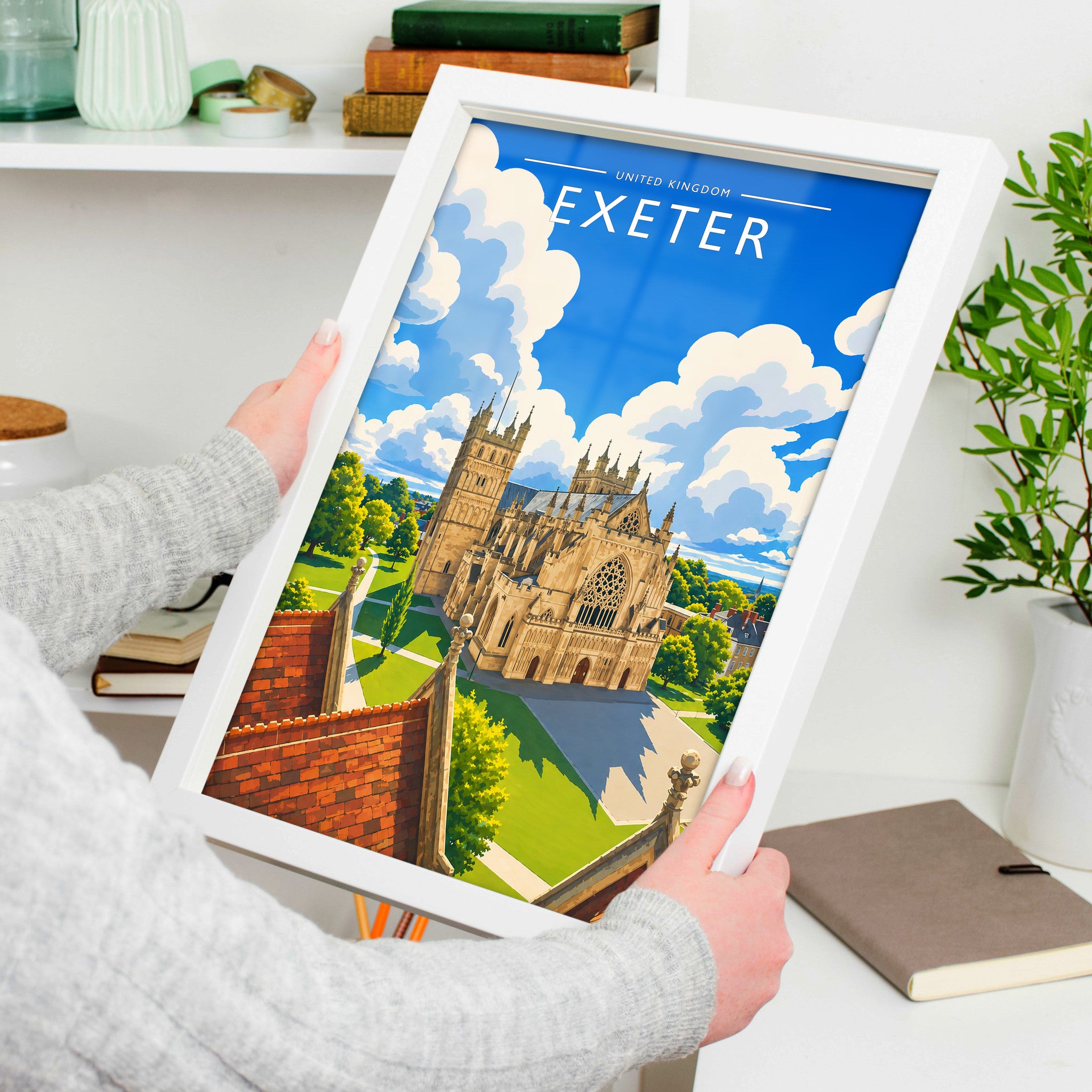 Exeter Travel Poster in a white frame, held to show scale