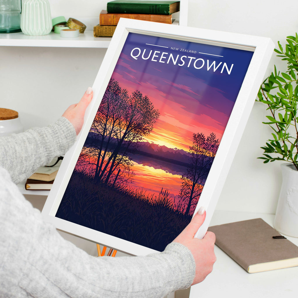 Queenstown Travel Poster in a white frame, held to show scale
