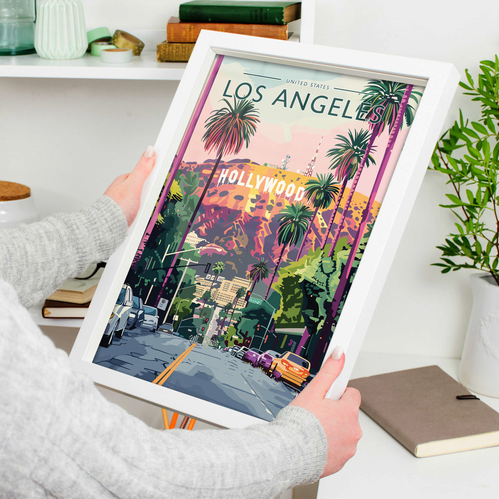 Los Angeles Travel Poster in a white frame, held to show scale