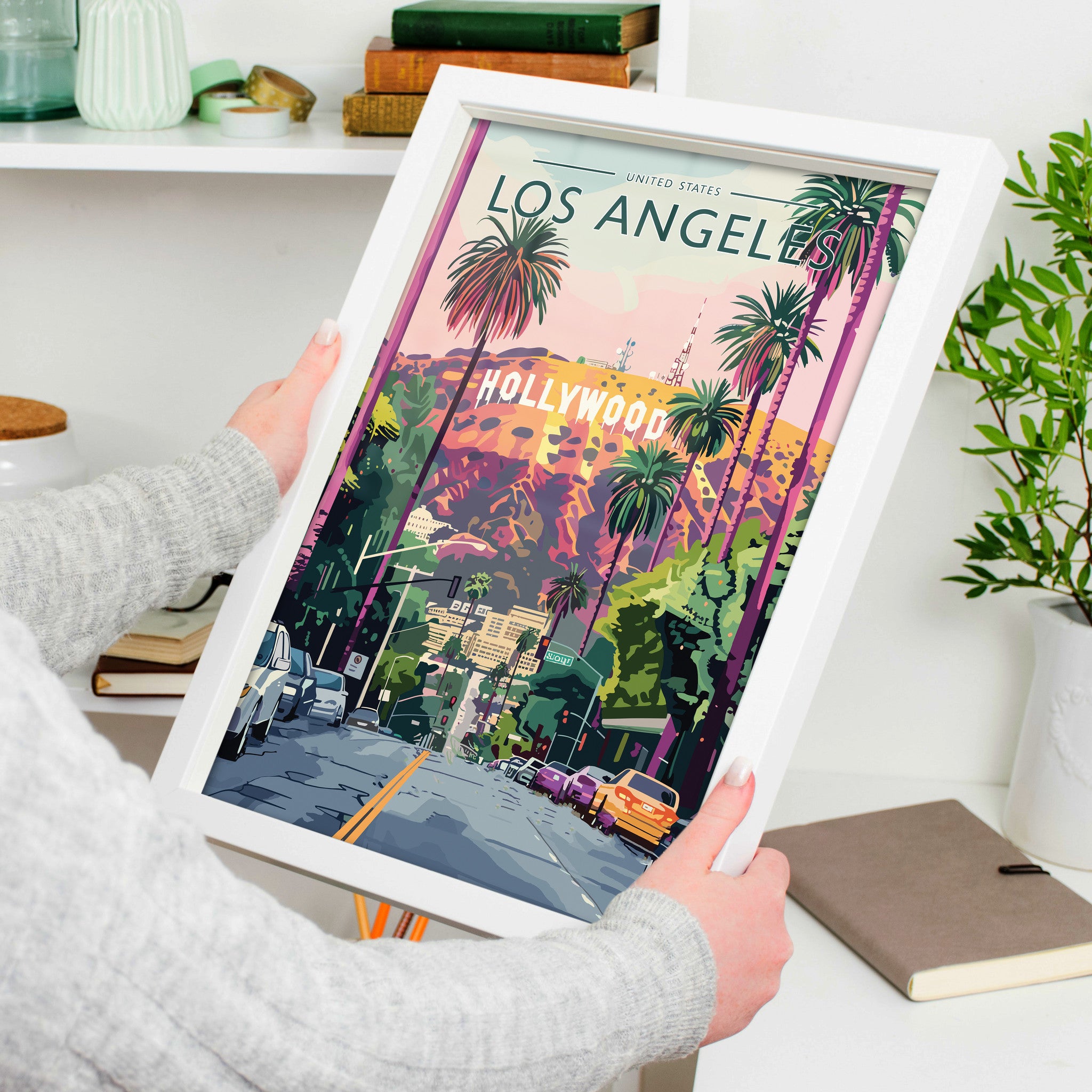 Los Angeles Travel Poster in a white frame, held to show scale