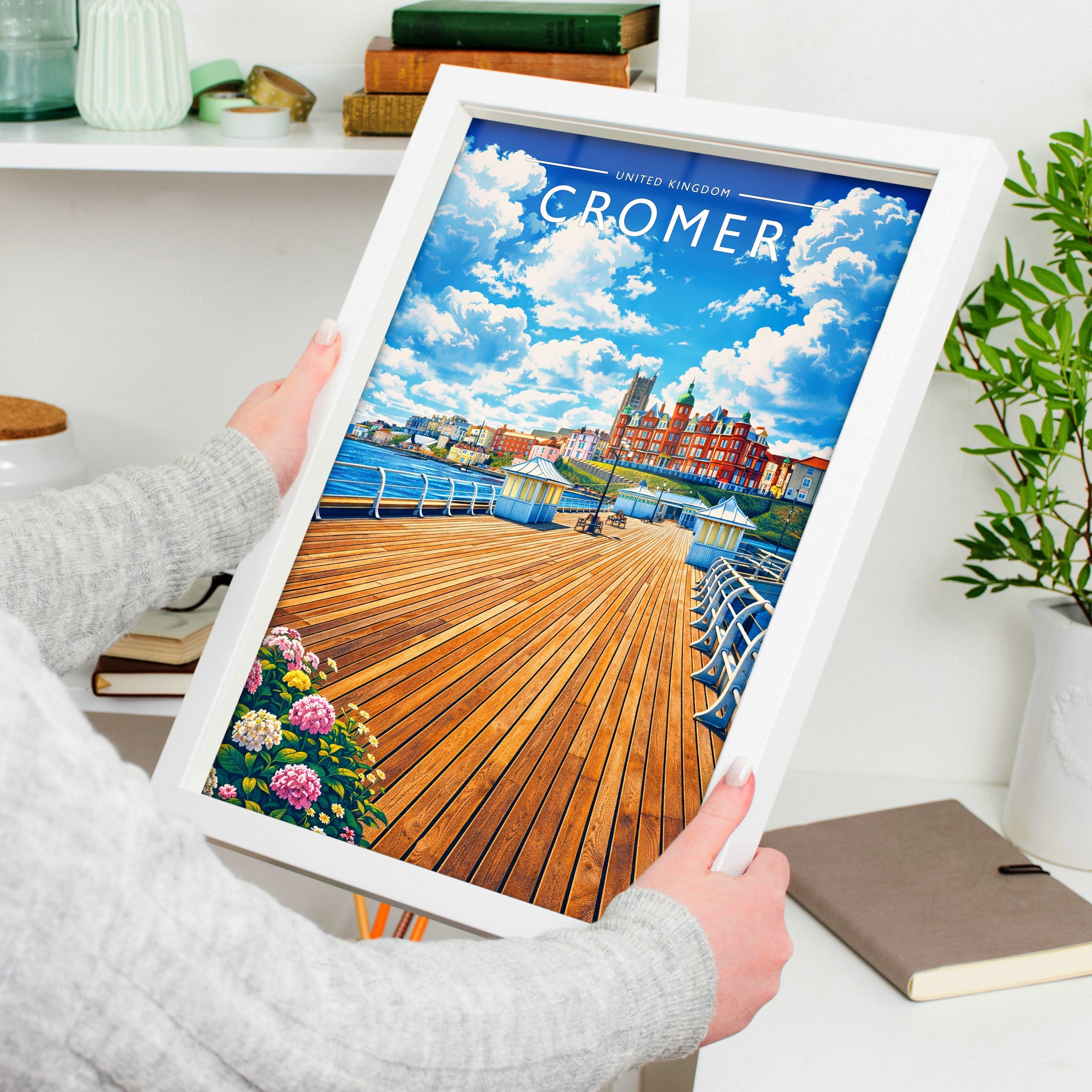 Cromer #2 Travel Poster in a white frame, held to show scale