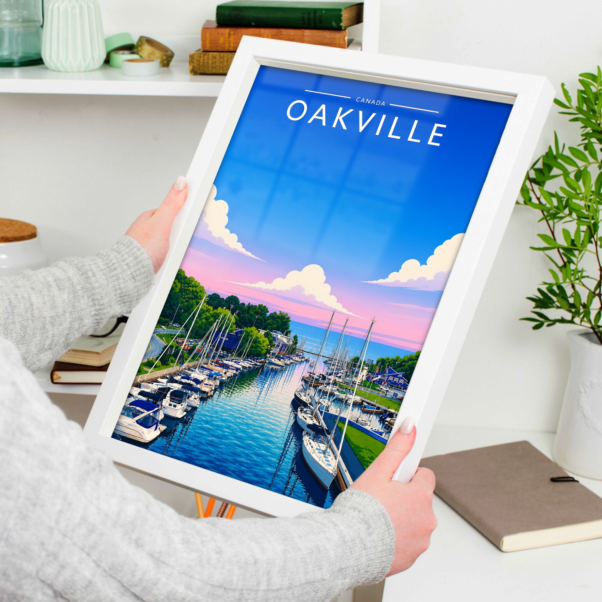 Oakville Travel Poster in a white frame, held to show scale