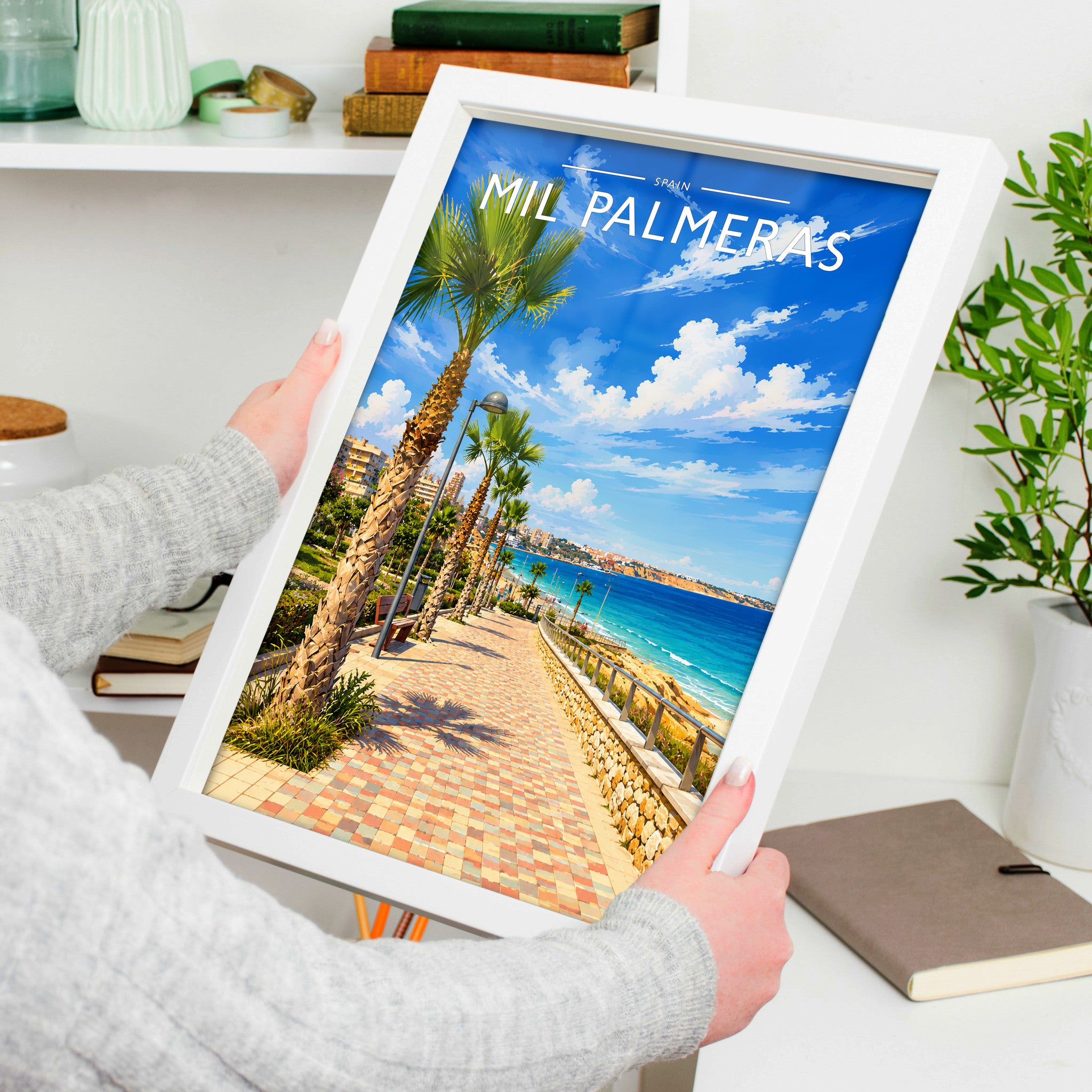 Mil Palmeras Travel Poster in a white frame, held to show scale