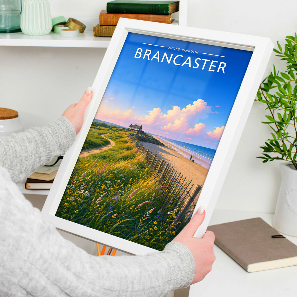 Brancaster #2 Travel Poster in a white frame, held to show scale