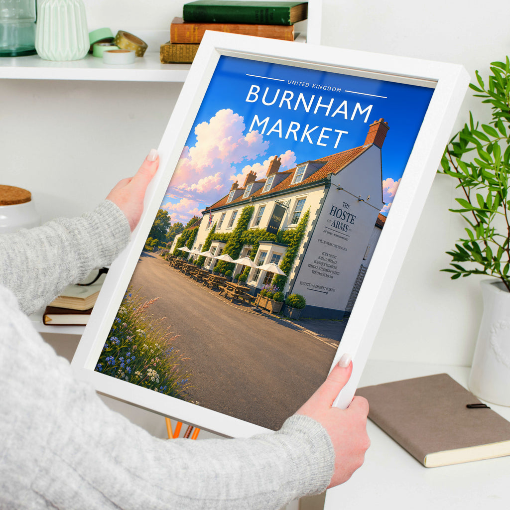 Burnham Market #3 Travel Poster in a white frame, held to show scale