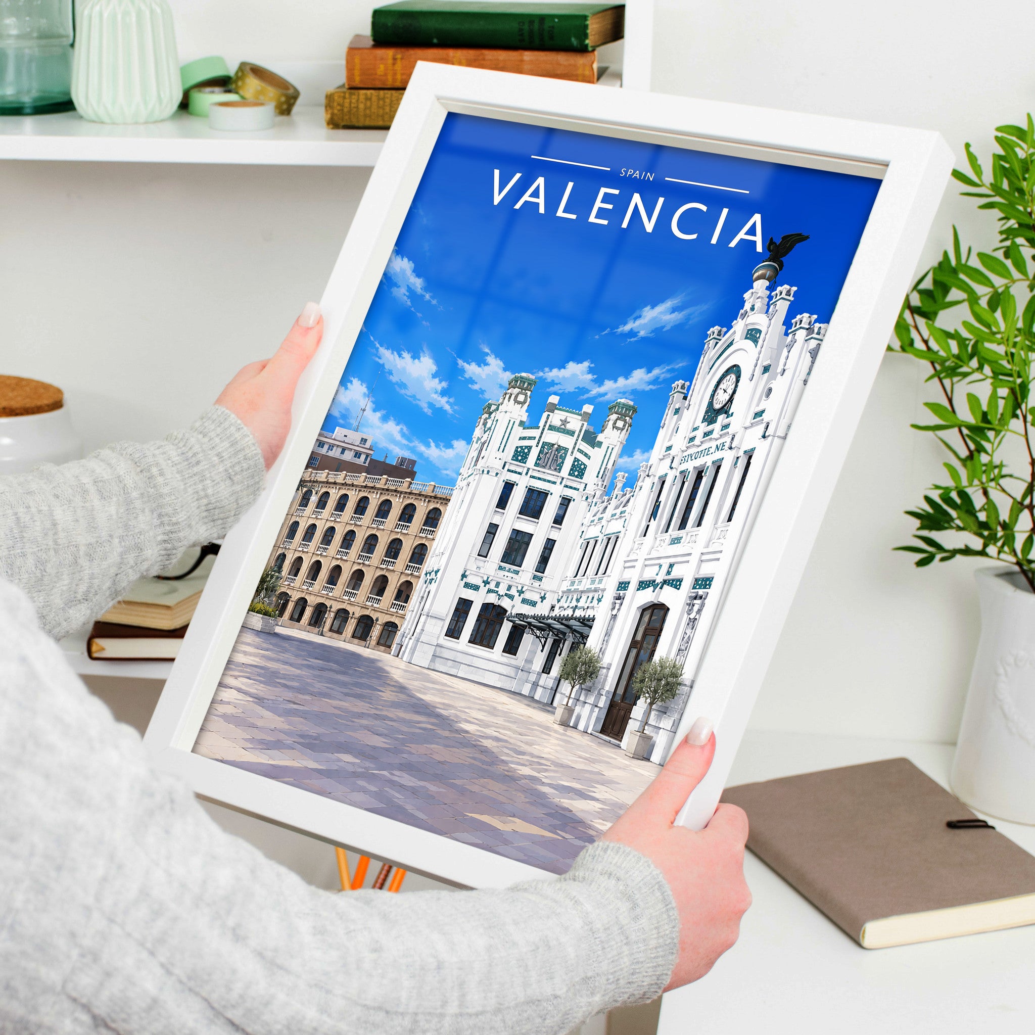 Valencia #2 Travel Poster in a white frame, held to show scale