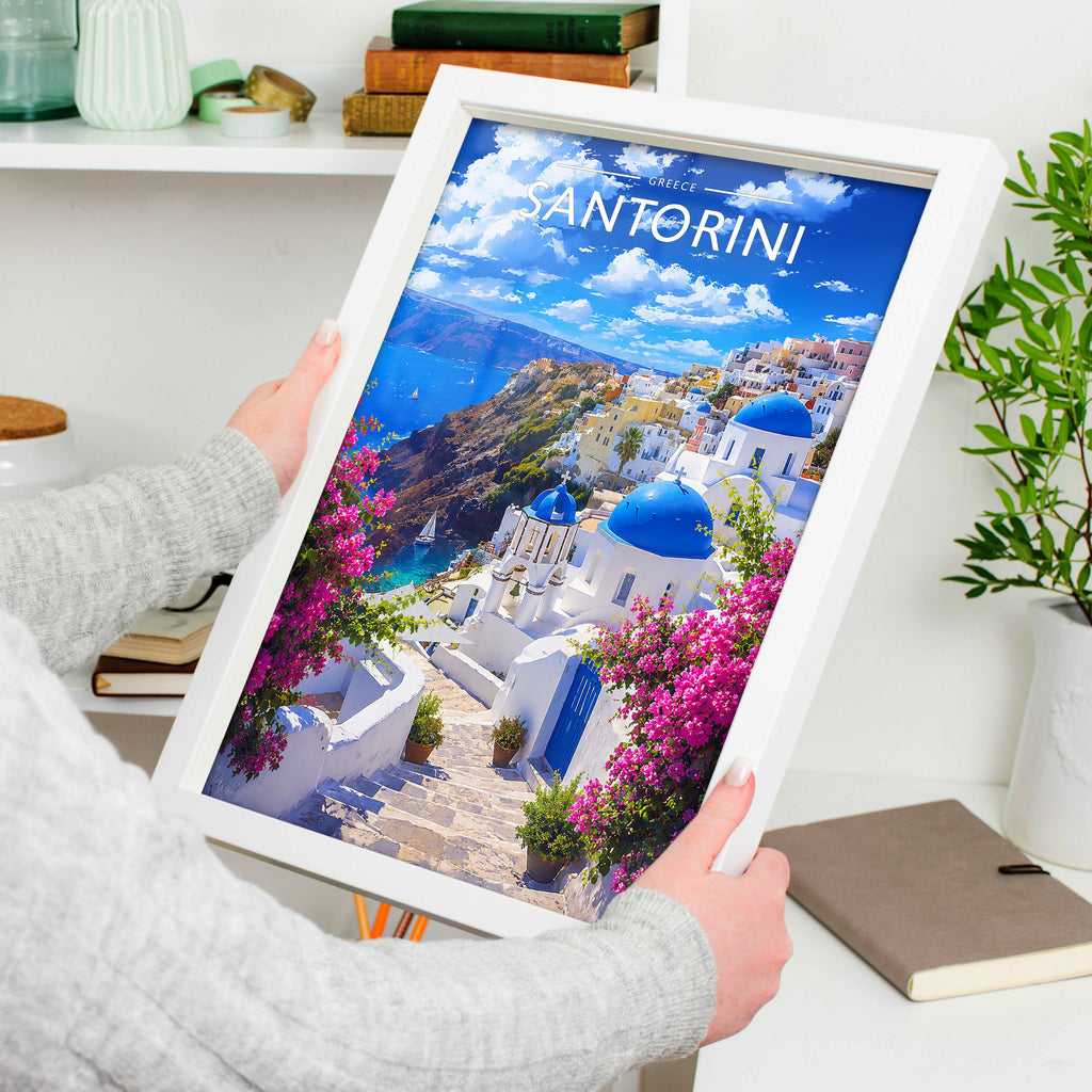Santorini Travel Poster in a white frame, held to show scale