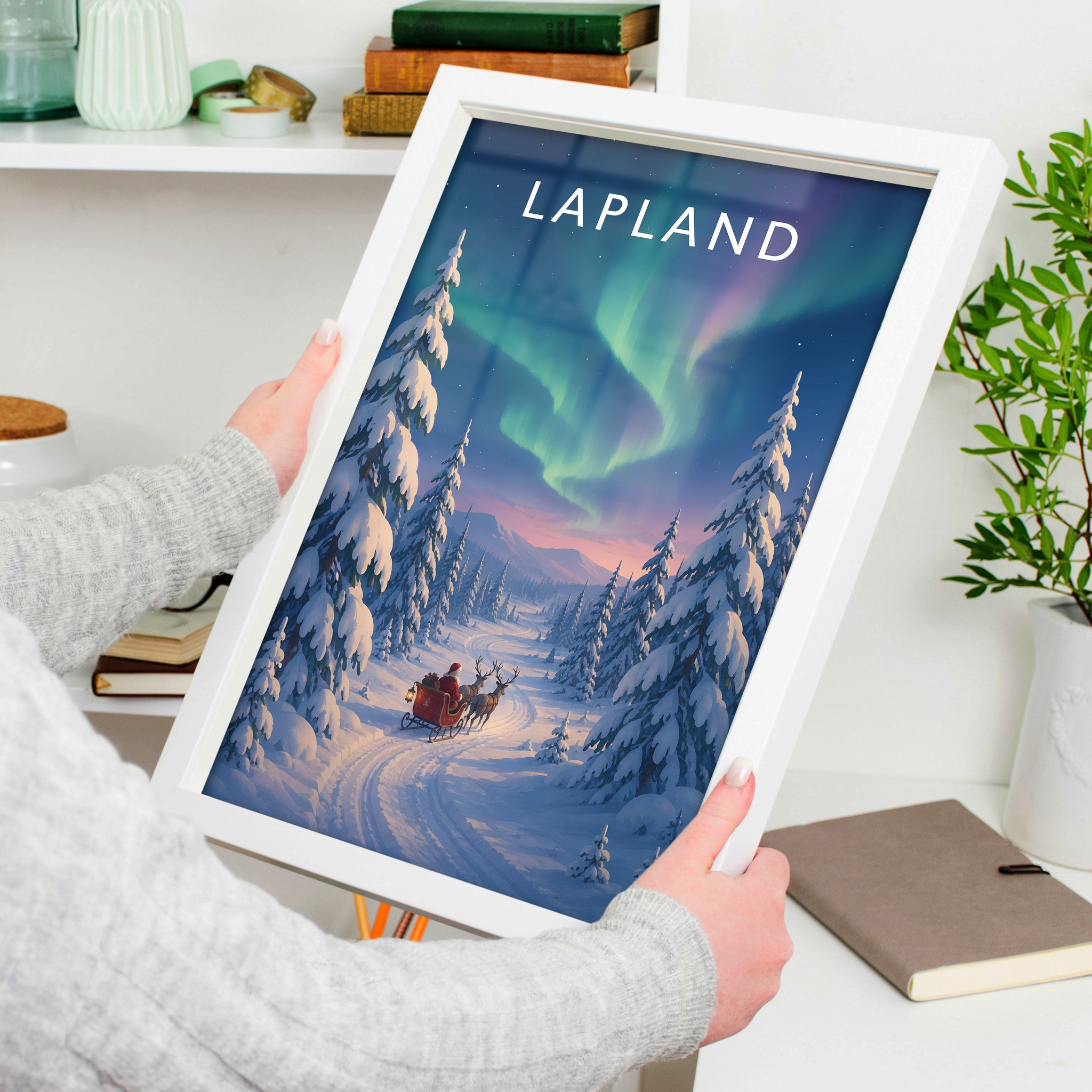 Lapland Travel Poster in a white frame, held to show scale