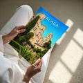 Malaga Travel Poster - A4 print held in hand