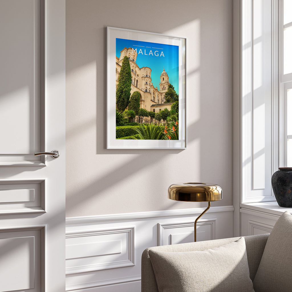 Malaga Travel Poster in a white frame on a panelled wall