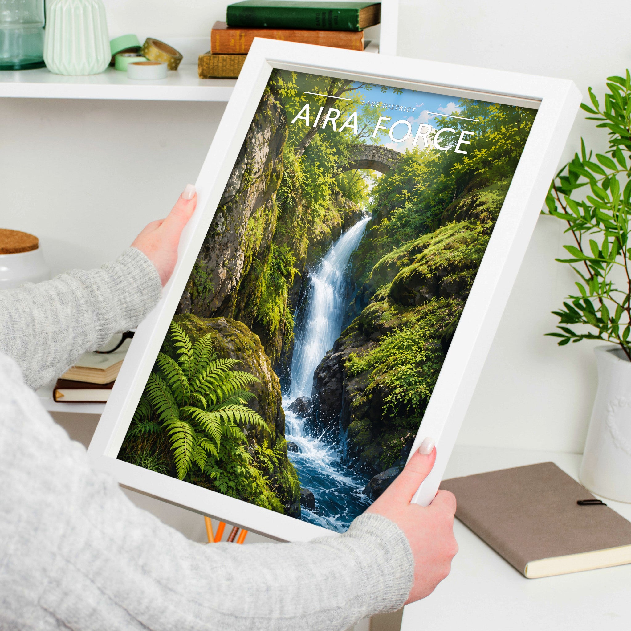 Aira Force Travel Poster in a white frame, held to show scale
