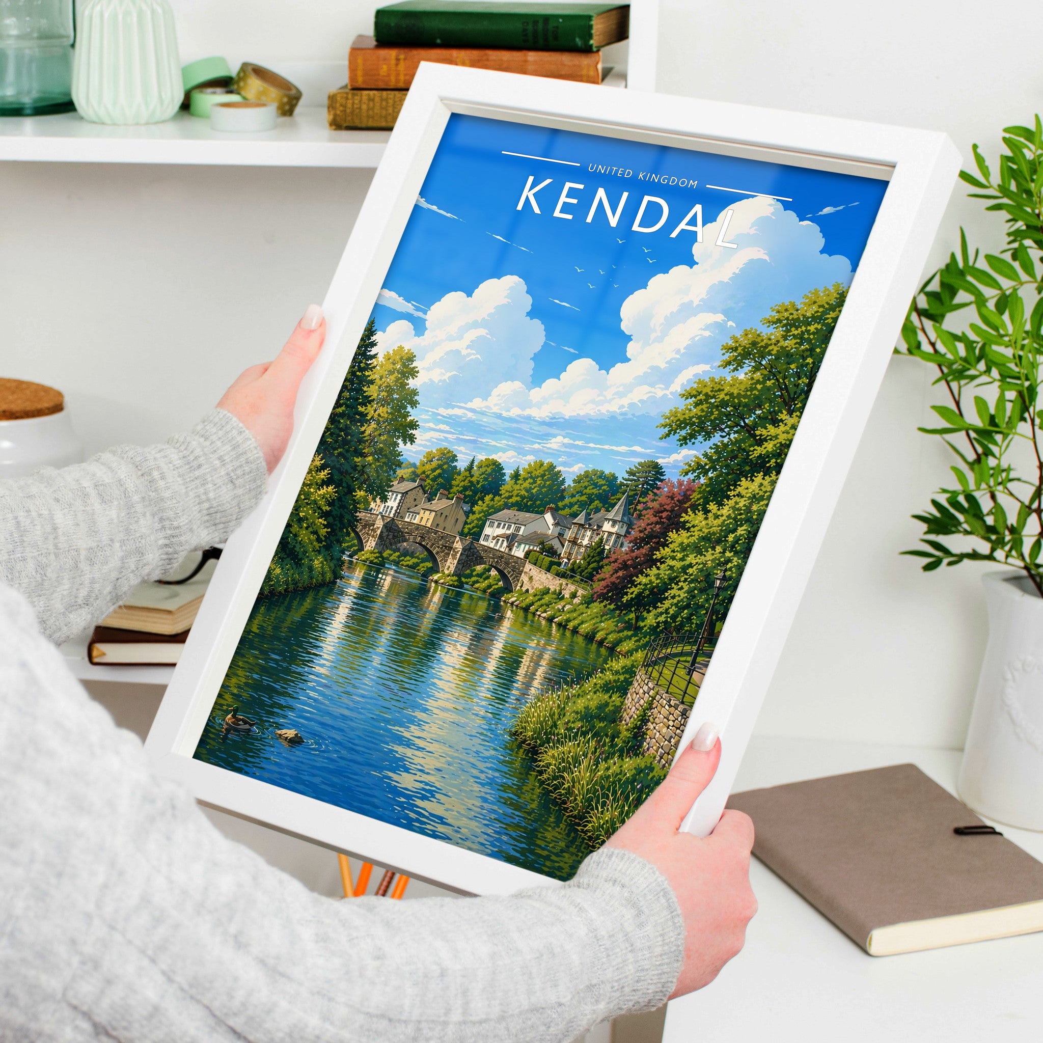 Kendal Travel Poster in a white frame, held to show scale