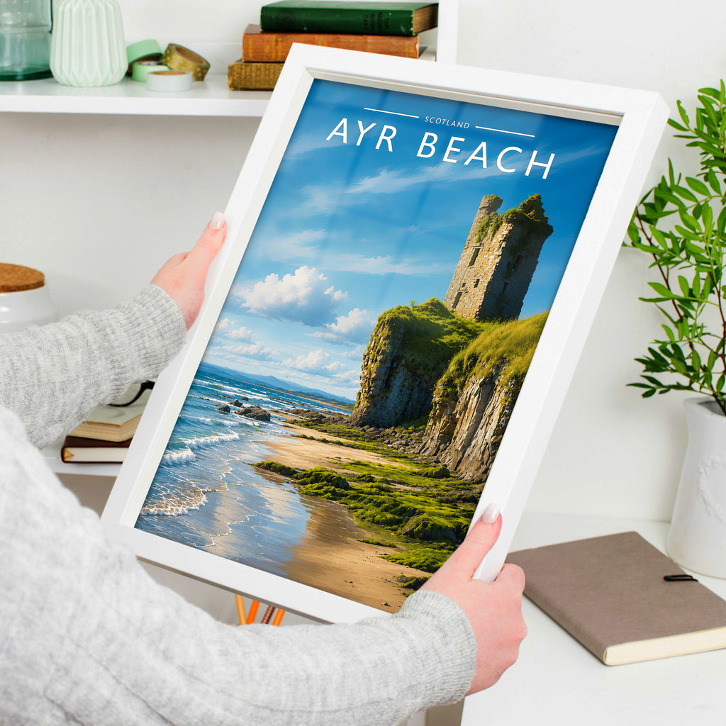Ayr Beach Travel Poster in a white frame, held to show scale