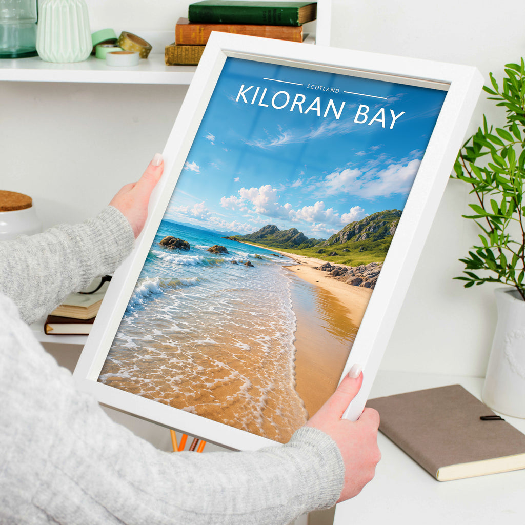 Kiloran Bay Travel Poster in a white frame, held to show scale
