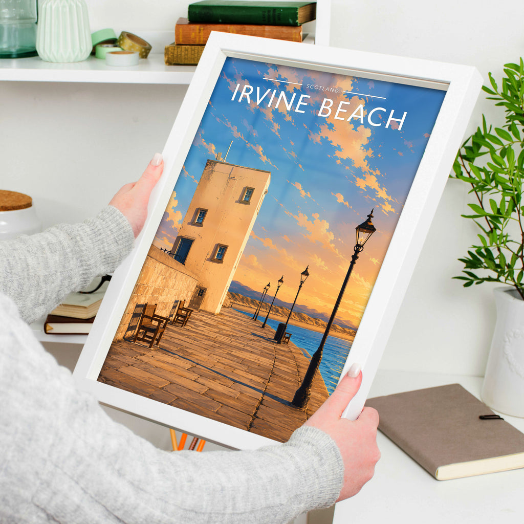Irvine Beach Travel Poster in a white frame, held to show scale